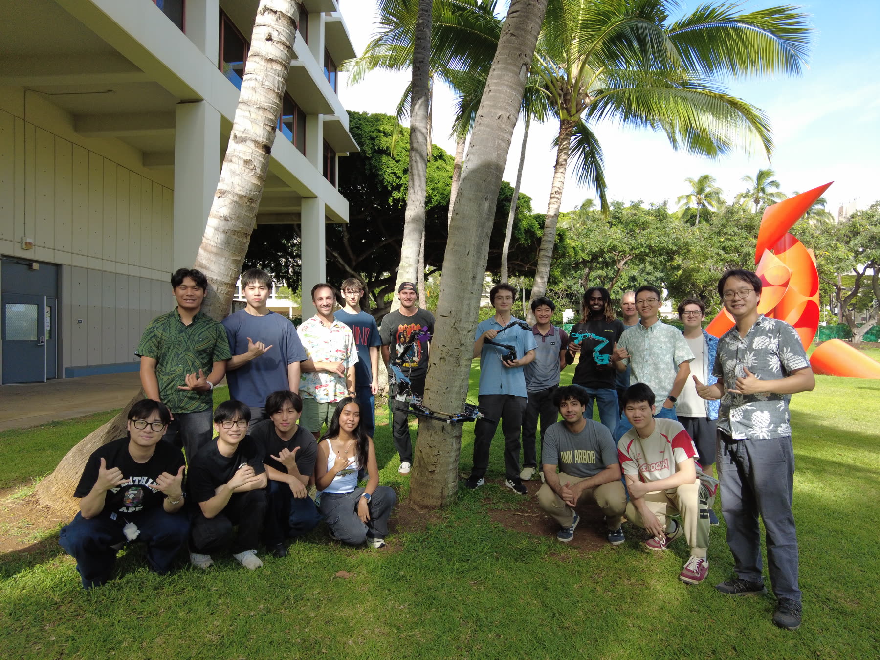 Farm Robotics Challenge team posing outdoors with robot arms